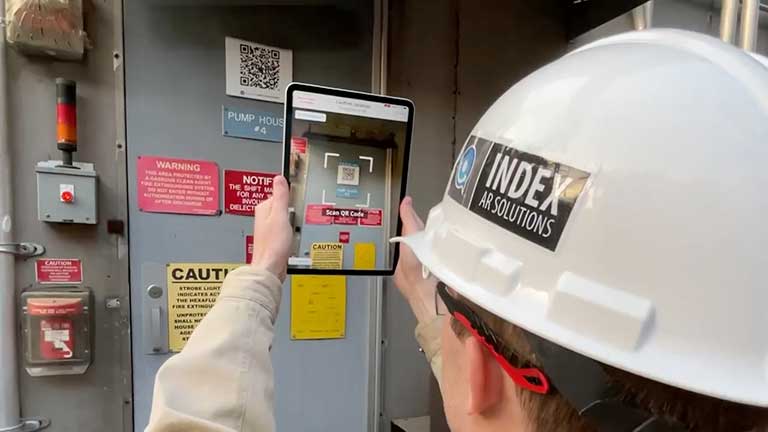 An electrical worker uses a critical task mobile application to gain entry to a pump house.