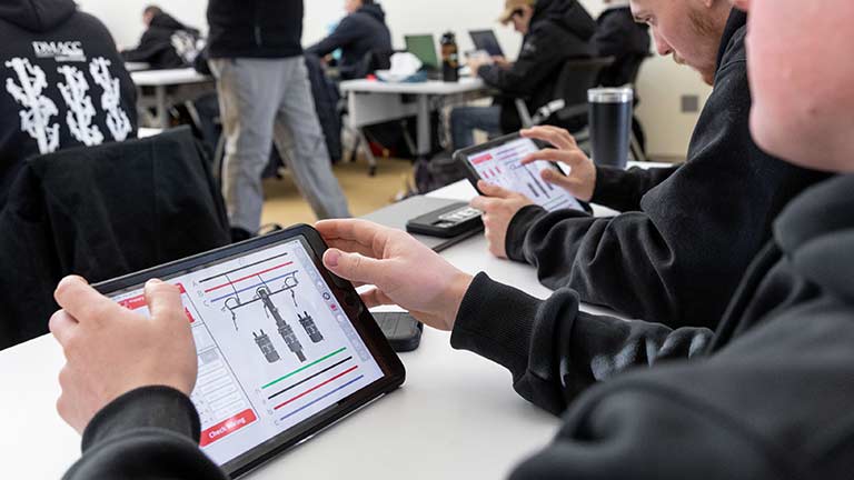 Students use a transformer training application in a classroom setting.